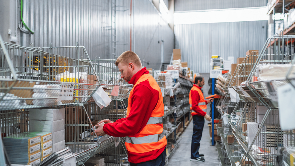 Warehouse workers handling orders in a logistics facility