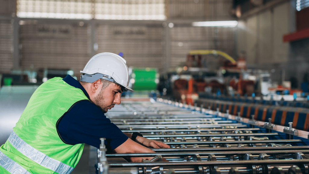 Worker monitoring an automated production line in a manufacturing facility