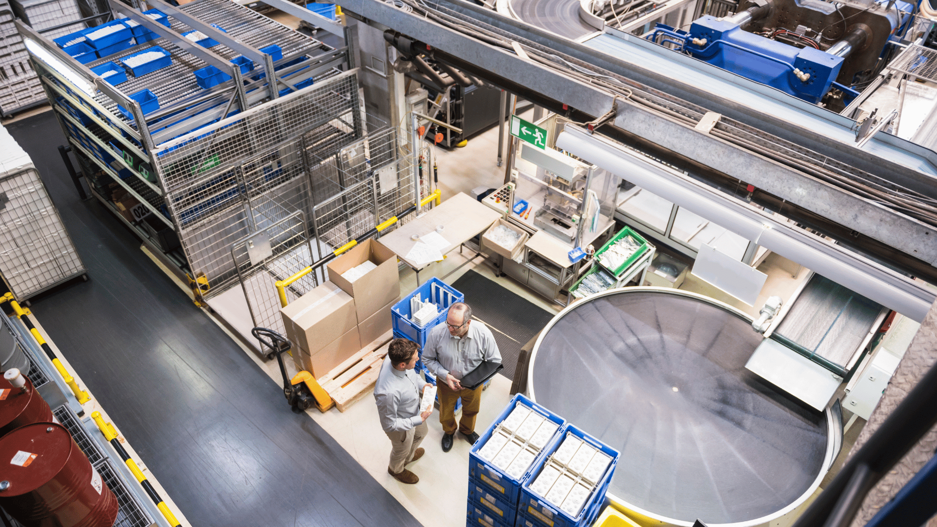 Employees working alongside automated systems in an industrial facility